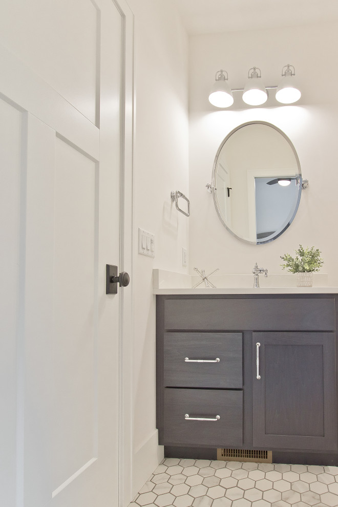 Photo of a transitional bathroom in Other with recessed-panel cabinets, dark wood cabinets, a freestanding tub, an alcove shower, white walls, mosaic tile floors, an undermount sink, engineered quartz benchtops, white floor, a hinged shower door, white benchtops, a single vanity and a built-in vanity.