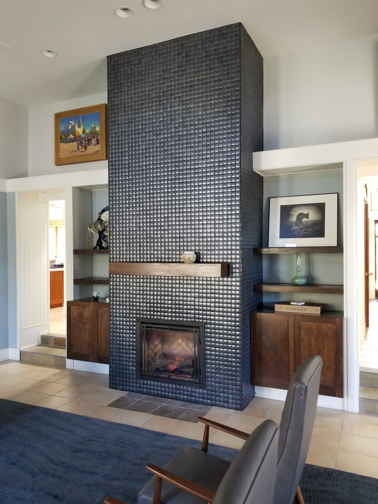 Photo of a medium sized classic living room in Albuquerque with blue walls, ceramic flooring, a standard fireplace, a tiled fireplace surround, beige floors and tongue and groove walls.