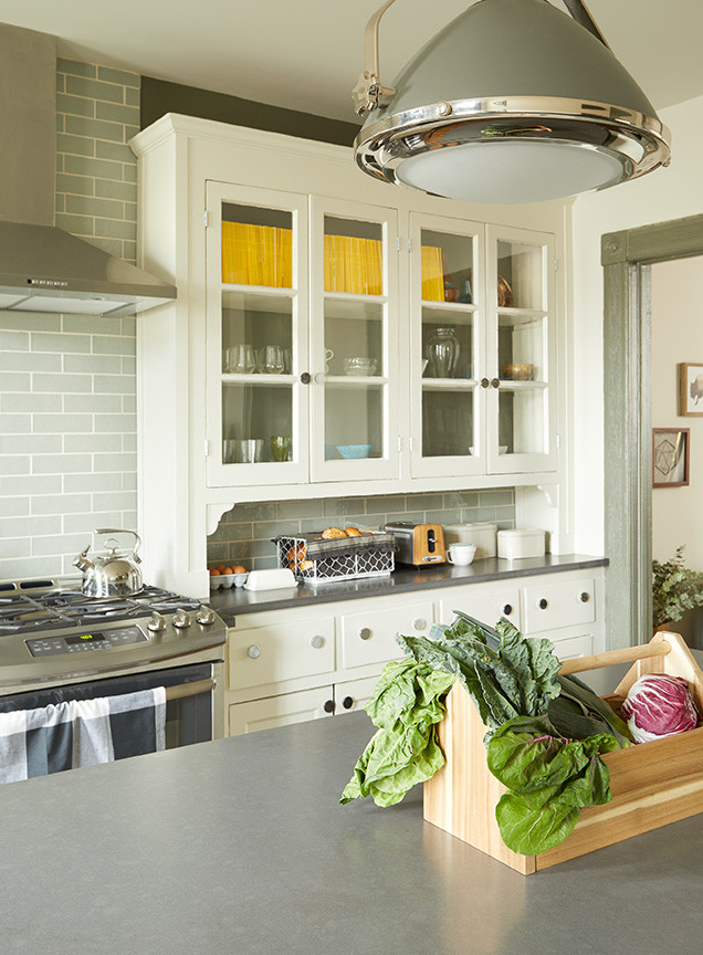 Inspiration for a mid-sized country galley eat-in kitchen in New York with a farmhouse sink, ceramic splashback, dark hardwood floors, with island, brown floor, louvered cabinets, beige cabinets, laminate benchtops, grey splashback and stainless steel appliances.