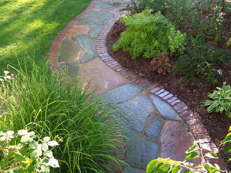 Inspiration for a mid-sized transitional full sun garden for summer in Chicago with a garden path and natural stone pavers.