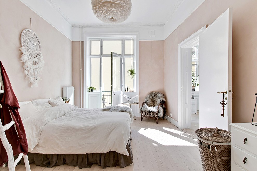 This is an example of a large scandinavian master bedroom in Other with beige walls, light hardwood floors and beige floor.