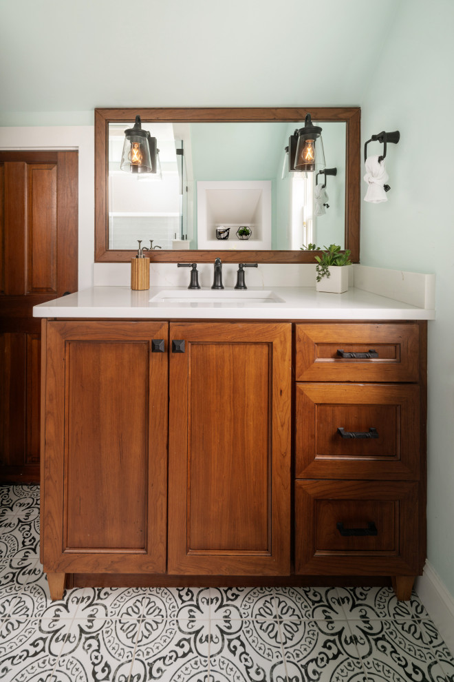 Photo of a mid-sized country 3/4 bathroom in Philadelphia with recessed-panel cabinets, distressed cabinets, a corner shower, white tile, ceramic tile, ceramic floors, an undermount sink, solid surface benchtops, a hinged shower door, white benchtops, a shower seat, a single vanity and a freestanding vanity.