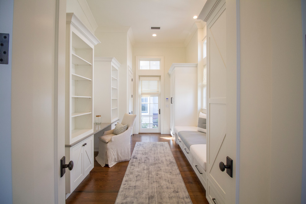 Design ideas for a beach style hallway in Miami with white walls and dark hardwood floors.