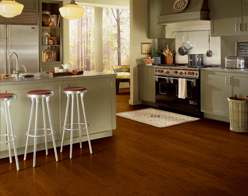 Inspiration for a large transitional l-shaped medium tone wood floor and brown floor enclosed kitchen remodel with granite countertops, beige backsplash, stainless steel appliances, an island, an undermount sink, beaded inset cabinets and green cabinets