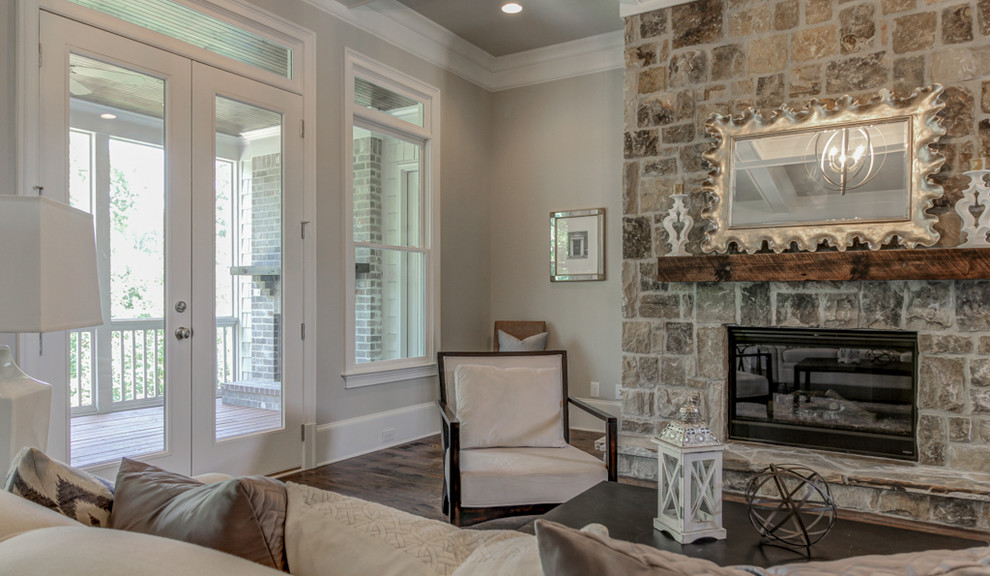 Design ideas for a large traditional open concept living room in Atlanta with grey walls, dark hardwood floors, a standard fireplace, a stone fireplace surround and a wall-mounted tv.