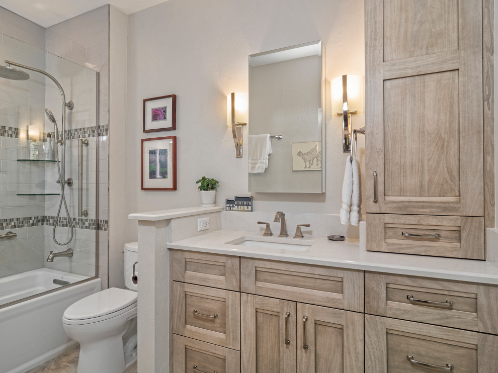 Example of a mid-sized transitional kids' gray tile and porcelain tile porcelain tile, beige floor and single-sink bathroom design in Miami with flat-panel cabinets, light wood cabinets, a two-piece toilet, beige walls, an undermount sink, quartz countertops, a hinged shower door, white countertops and a built-in vanity