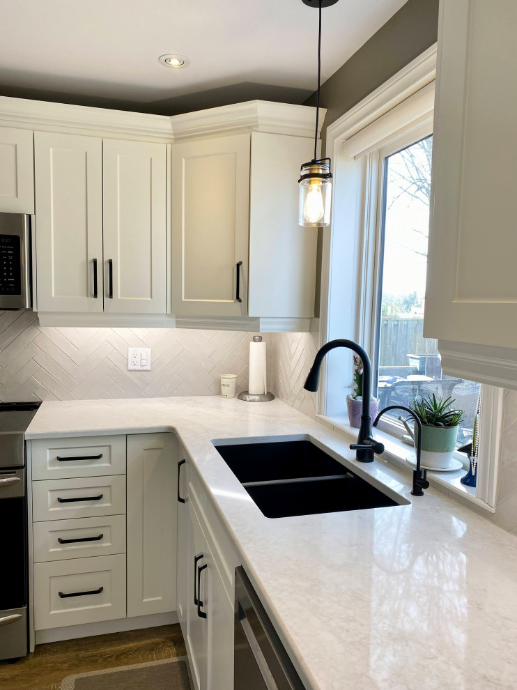 Mid-sized transitional l-shaped separate kitchen in Other with a double-bowl sink, recessed-panel cabinets, white cabinets, grey splashback, glass tile splashback and no island.