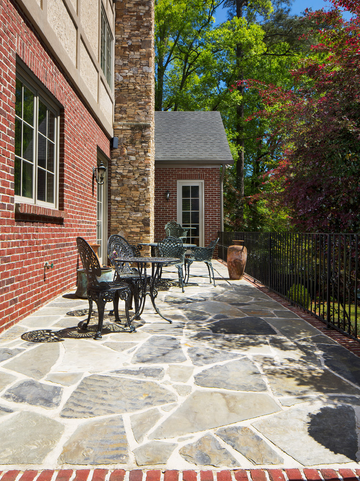 Inspiration for a large traditional backyard patio in Birmingham with a water feature, brick pavers and a gazebo/cabana.