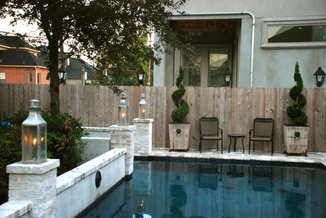Example of a mid-sized transitional backyard stone and rectangular lap pool design in Orange County