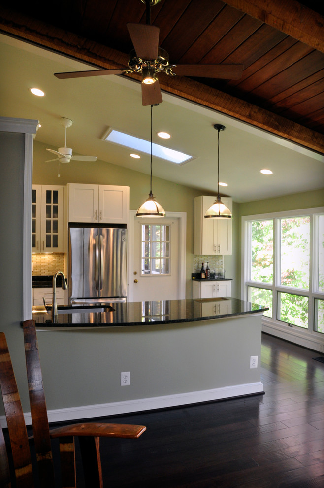 Mid-sized transitional u-shaped dark wood floor eat-in kitchen photo in DC Metro with an undermount sink, shaker cabinets, white cabinets, granite countertops, yellow backsplash, glass tile backsplash, stainless steel appliances and a peninsula