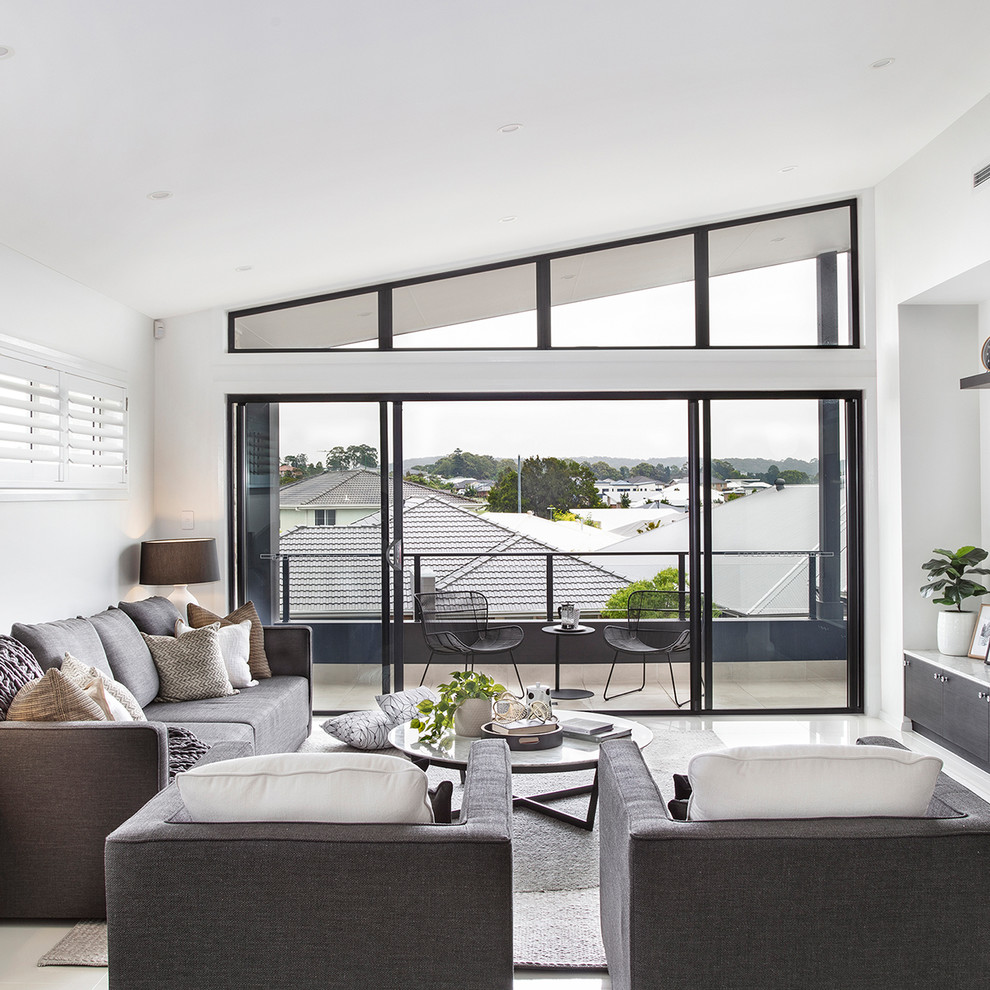Inspiration for a large contemporary open concept living room in Wollongong with white walls, ceramic floors, a wall-mounted tv and white floor.