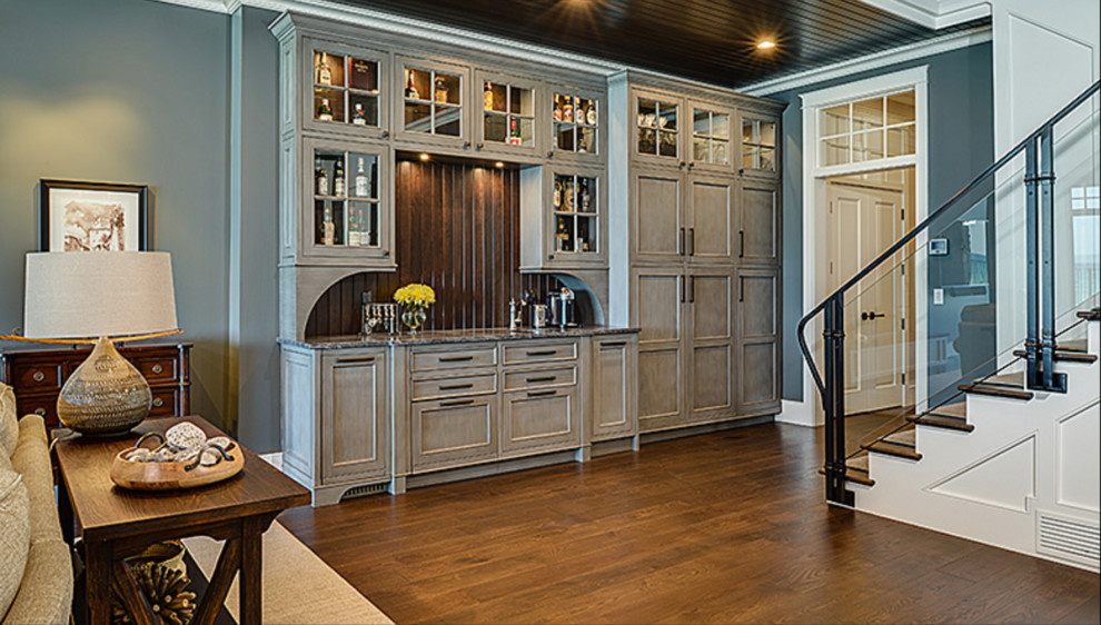Large transitional look-out dark wood floor and brown floor basement photo with blue walls