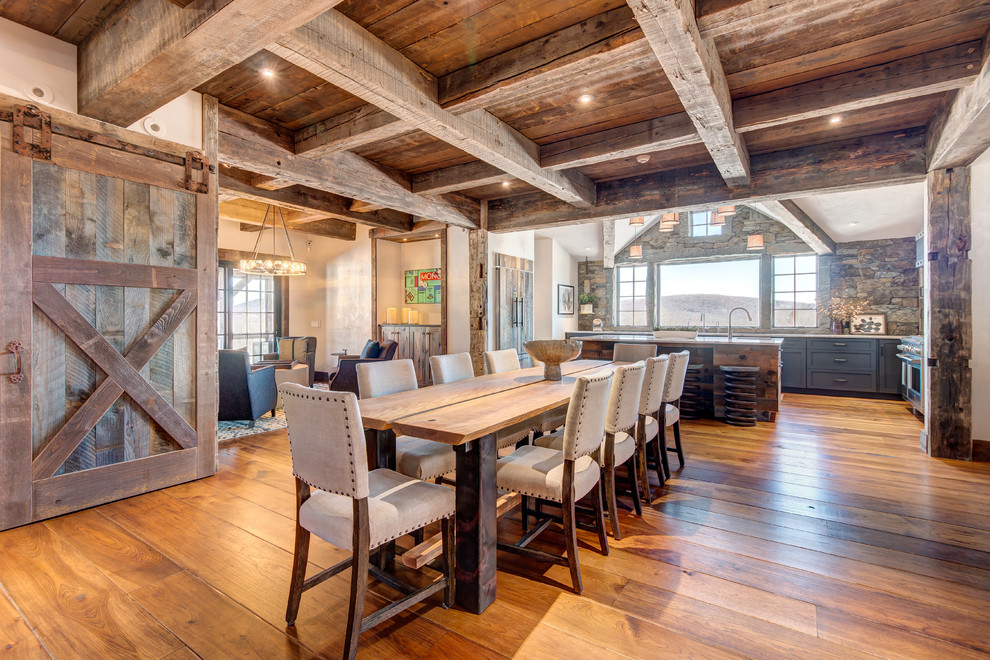 Mountain style medium tone wood floor kitchen/dining room combo photo in Boston with white walls