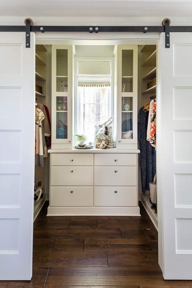 Photo of a country women's walk-in wardrobe in Birmingham with flat-panel cabinets, white cabinets and dark hardwood floors.