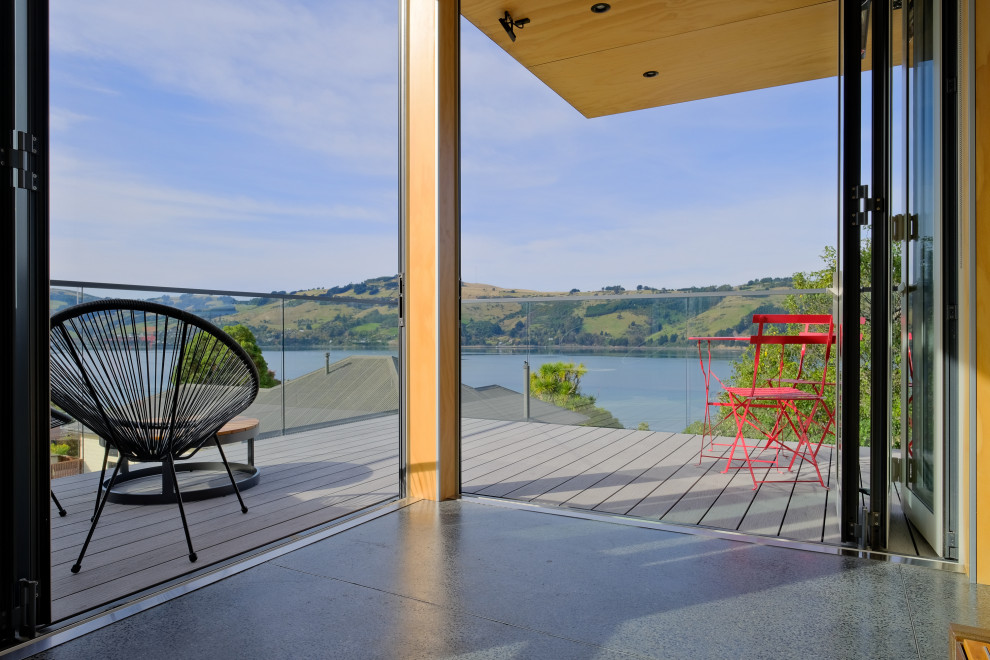 Mid-sized industrial Rooftop deck in Dunedin With a Roof Extension.