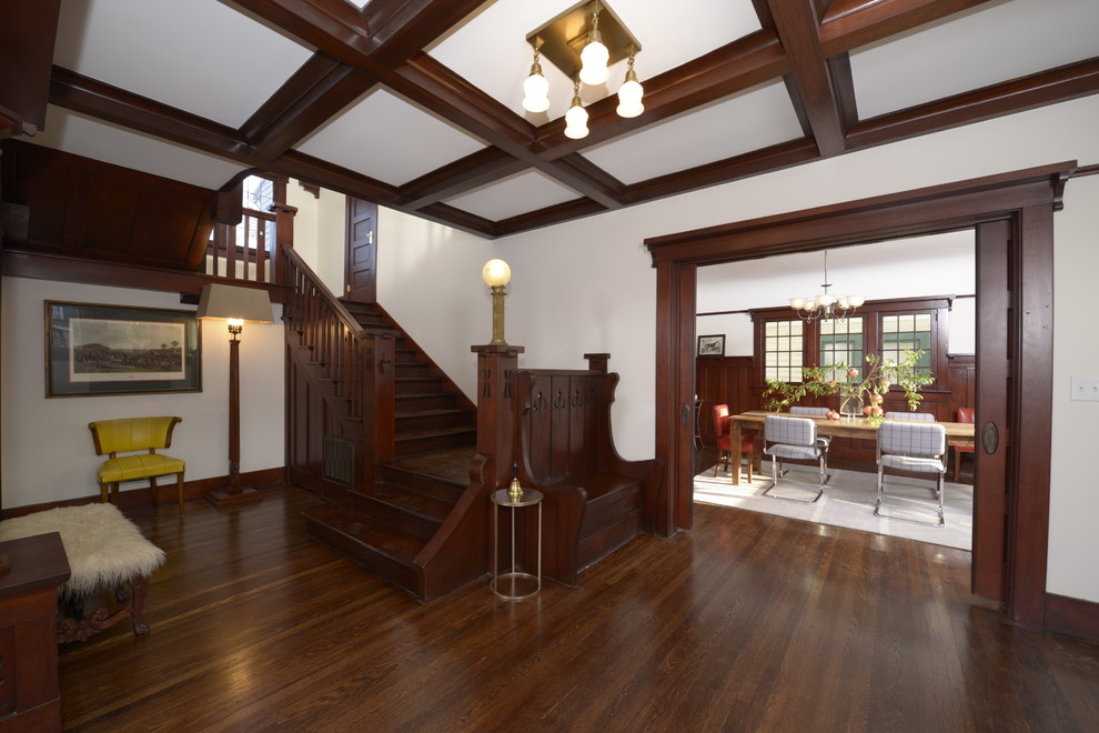 Inspiration for a large arts and crafts hallway in Los Angeles with white walls and dark hardwood floors.