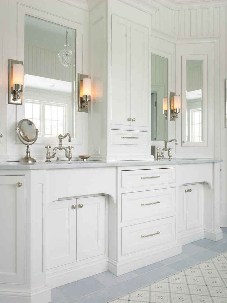 Design ideas for a traditional bathroom in New York with recessed-panel cabinets, white cabinets and white walls.