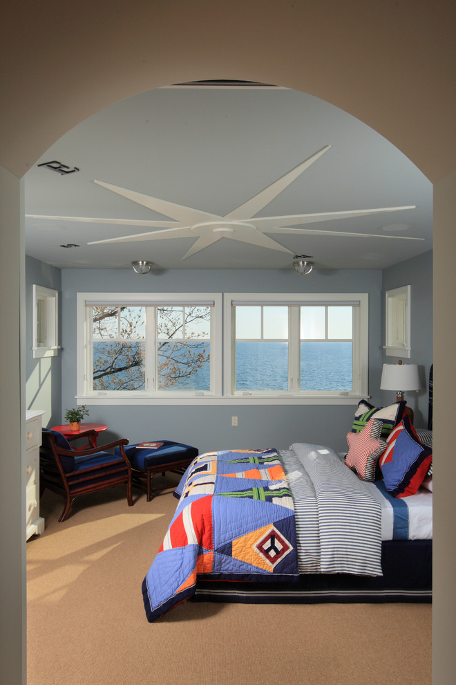 Inspiration for a beach style kids' bedroom for kids 4-10 years old and boys in Grand Rapids with blue walls and carpet.