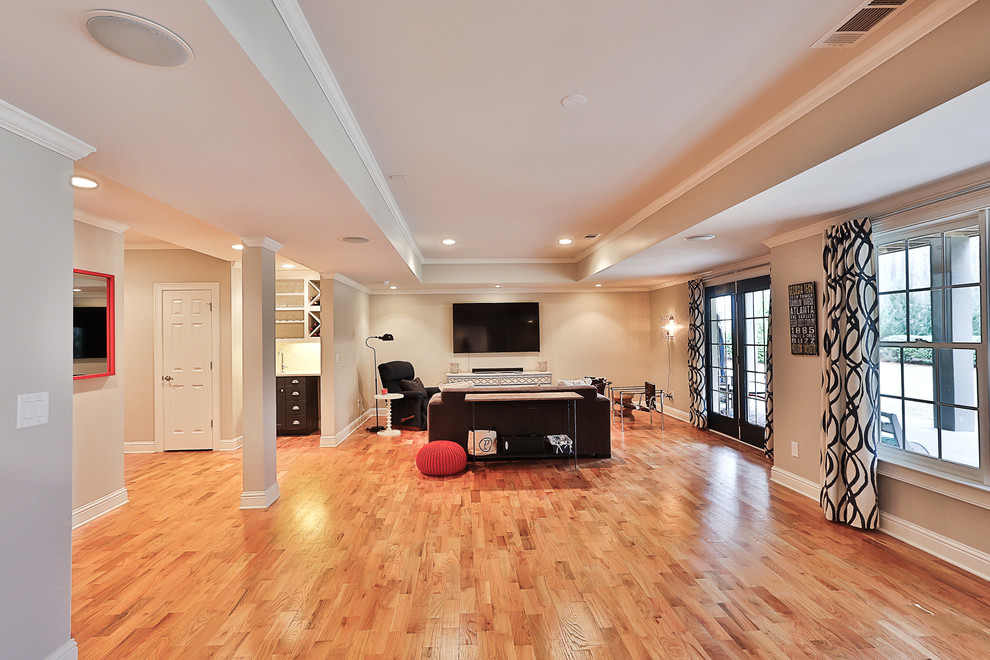 Photo of a mid-sized transitional walk-out basement in Atlanta with grey walls, light hardwood floors and no fireplace.