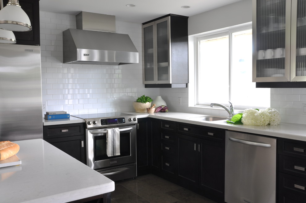 Inspiration for a mid-sized transitional l-shaped limestone floor eat-in kitchen remodel in Toronto with an undermount sink, shaker cabinets, dark wood cabinets, quartzite countertops, white backsplash, cement tile backsplash, stainless steel appliances and an island