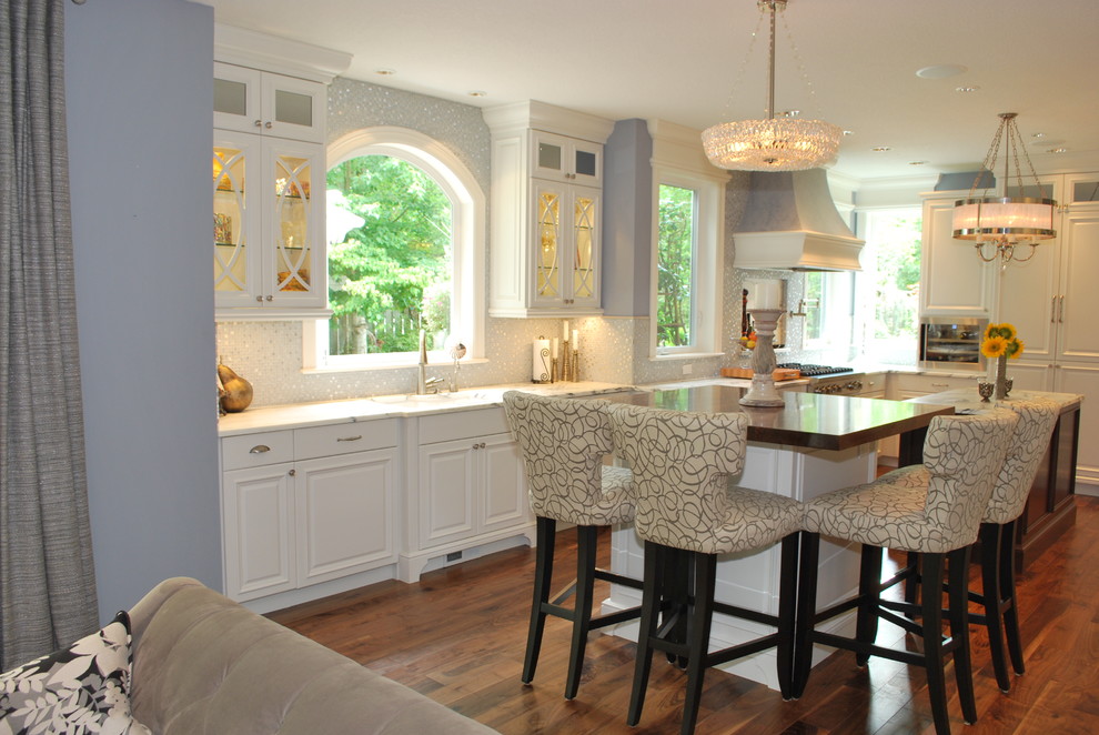Contemporary open plan kitchen in Portland with raised-panel cabinets and white cabinets.