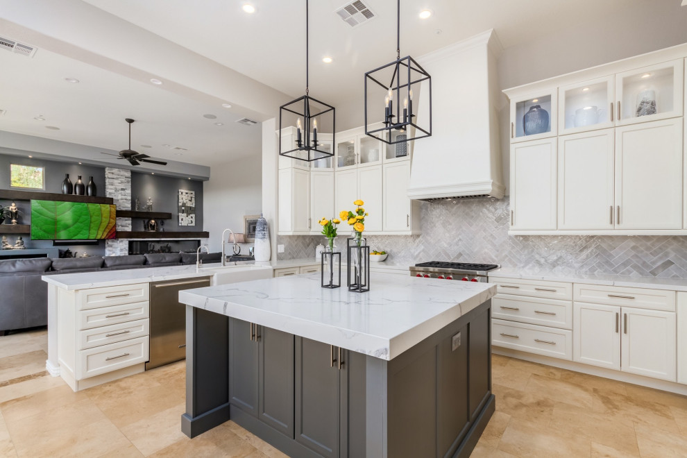 Large transitional u-shaped travertine floor and beige floor eat-in kitchen photo in Phoenix with a farmhouse sink, shaker cabinets, white cabinets, quartz countertops, gray backsplash, ceramic backsplash, stainless steel appliances, an island and white countertops