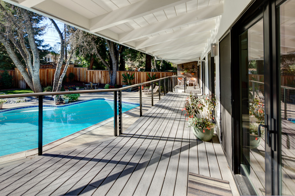 Photo of a mid-sized contemporary backyard deck in San Francisco with a roof extension.