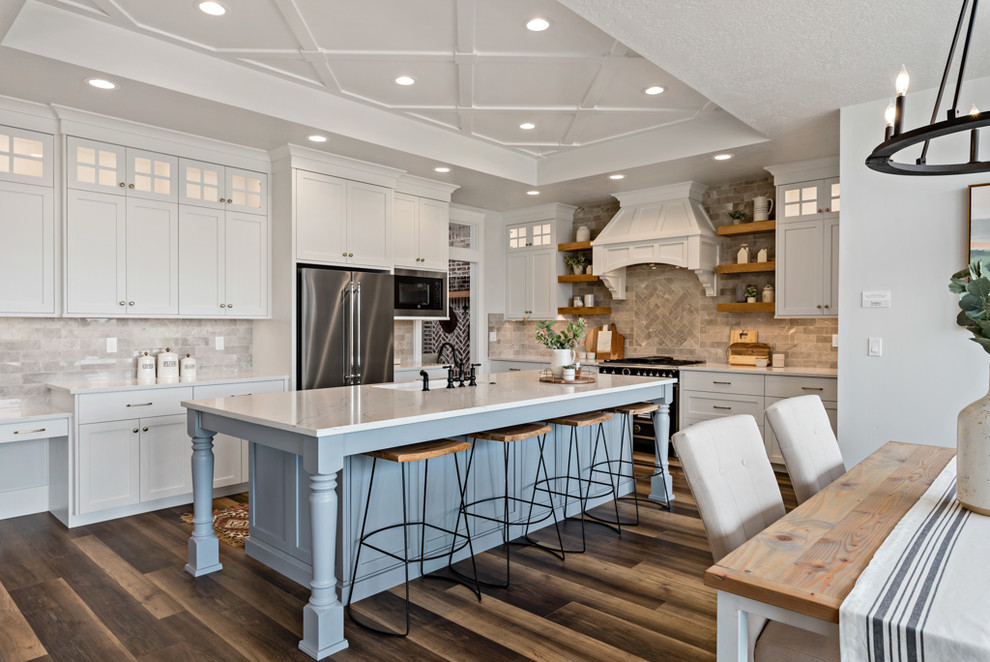 Inspiration for a country eat-in kitchen in Other with shaker cabinets, white cabinets, grey splashback, stainless steel appliances, dark hardwood floors, with island and white benchtop.