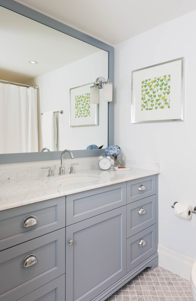 This is an example of a traditional bathroom in Toronto with recessed-panel cabinets and blue cabinets.