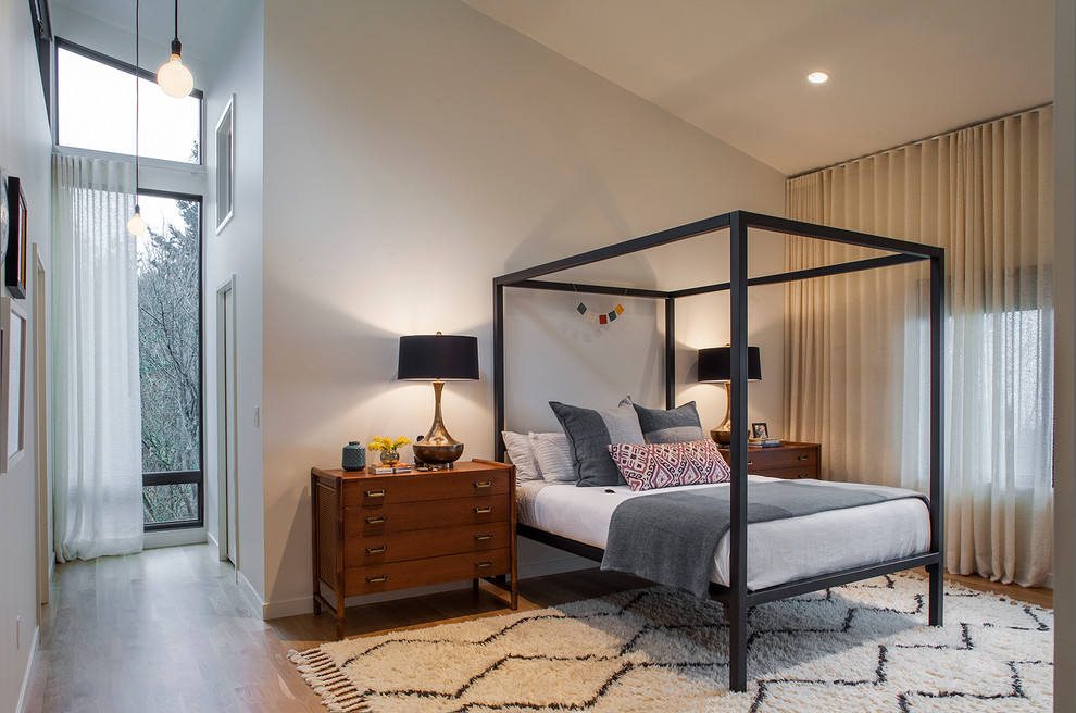Inspiration for a contemporary bedroom in Portland with grey walls and medium hardwood floors.