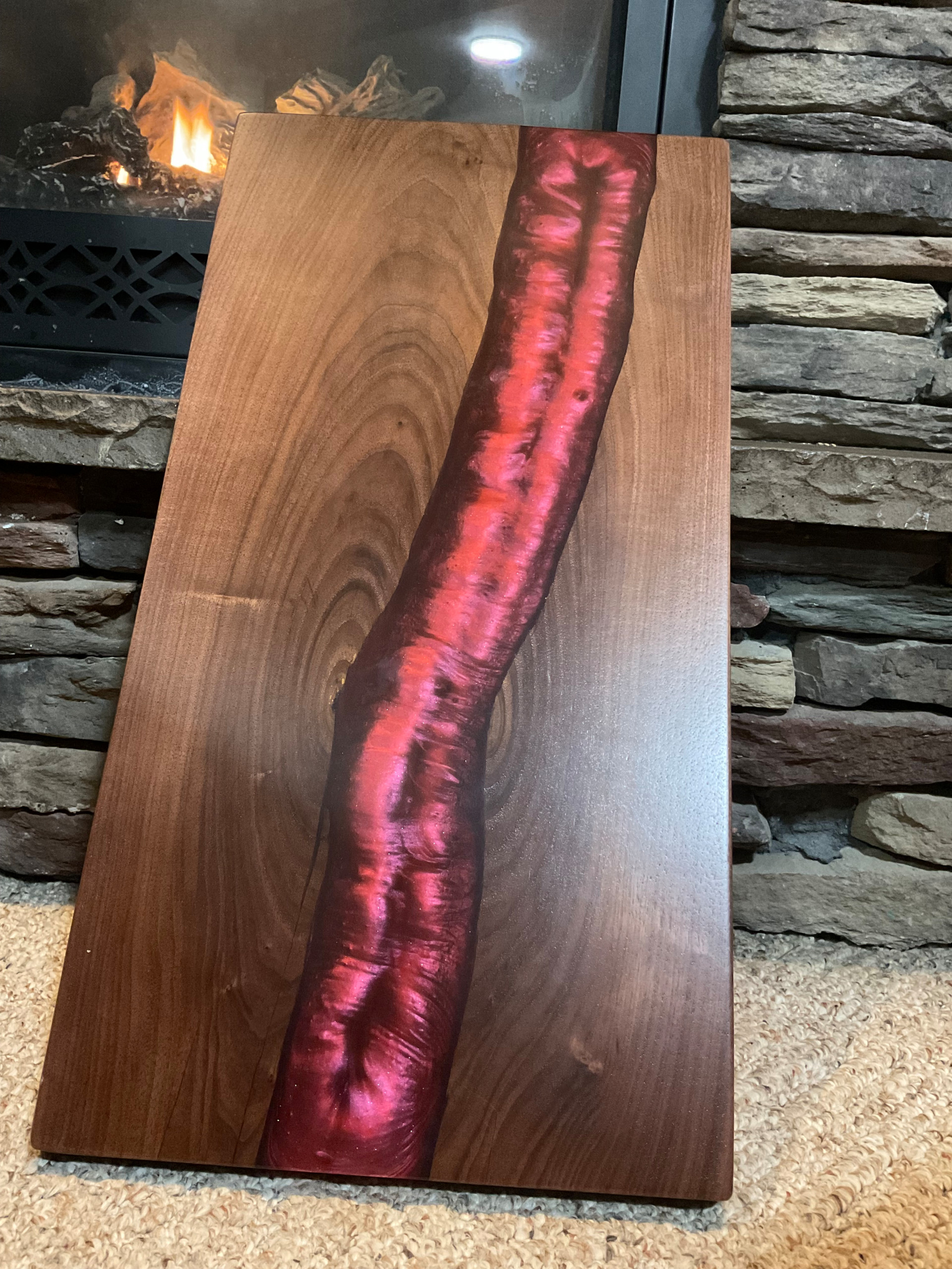 Walnut charcuterie board with red epoxy river