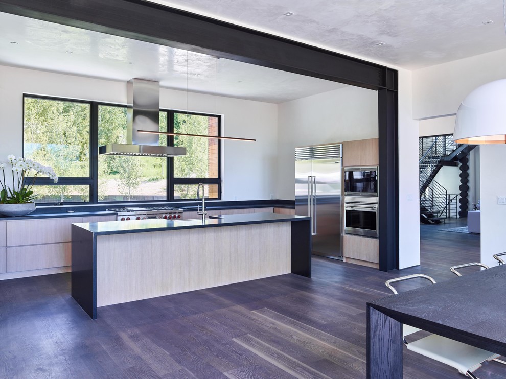 Inspiration for a contemporary eat-in kitchen in Jackson with yellow splashback, stainless steel appliances, dark hardwood floors and with island.