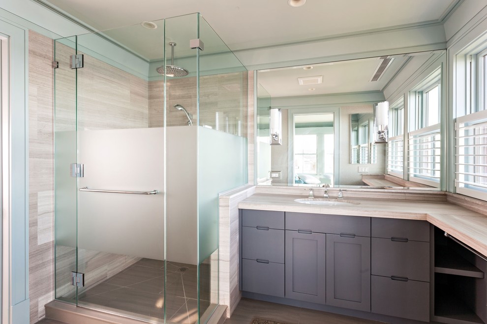 Inspiration for a large beach style master bathroom in Boston with flat-panel cabinets, grey cabinets, an alcove shower, beige tile, stone tile, blue walls, porcelain floors, an undermount sink and limestone benchtops.