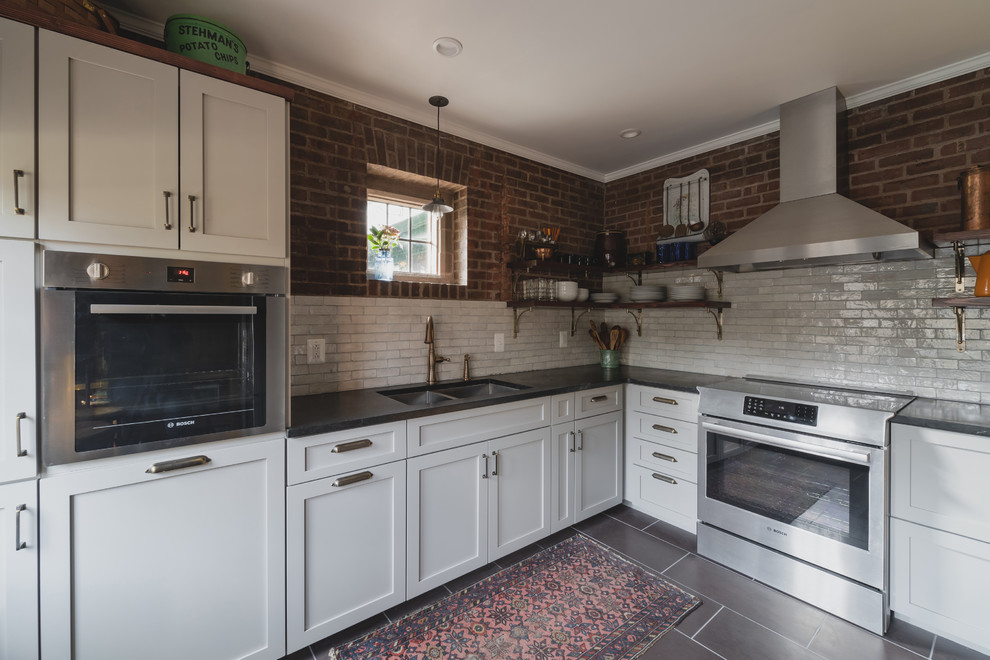 Small country l-shaped separate kitchen in Philadelphia with a double-bowl sink, shaker cabinets, grey cabinets, soapstone benchtops, white splashback, terra-cotta splashback, stainless steel appliances, slate floors, no island, purple floor and black benchtop.