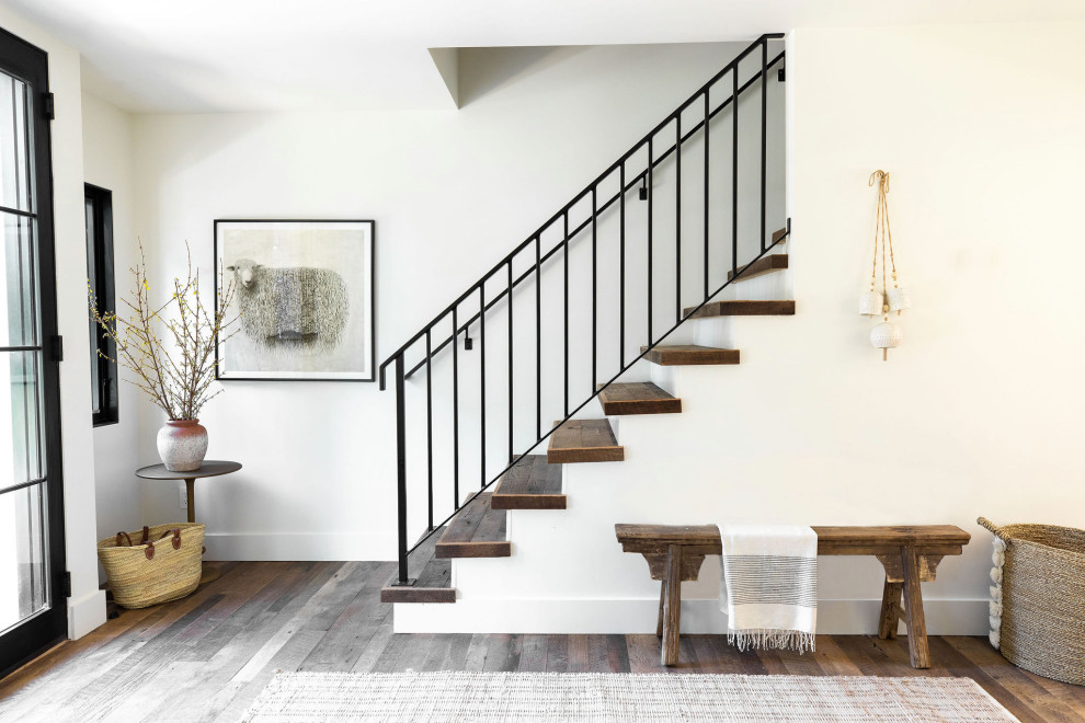 Country wood straight staircase in San Francisco with painted wood risers and metal railing.