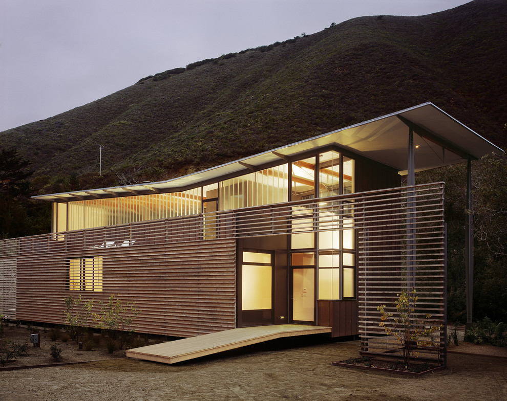 Mid-sized contemporary one-storey brown house exterior in San Francisco with mixed siding and a butterfly roof.