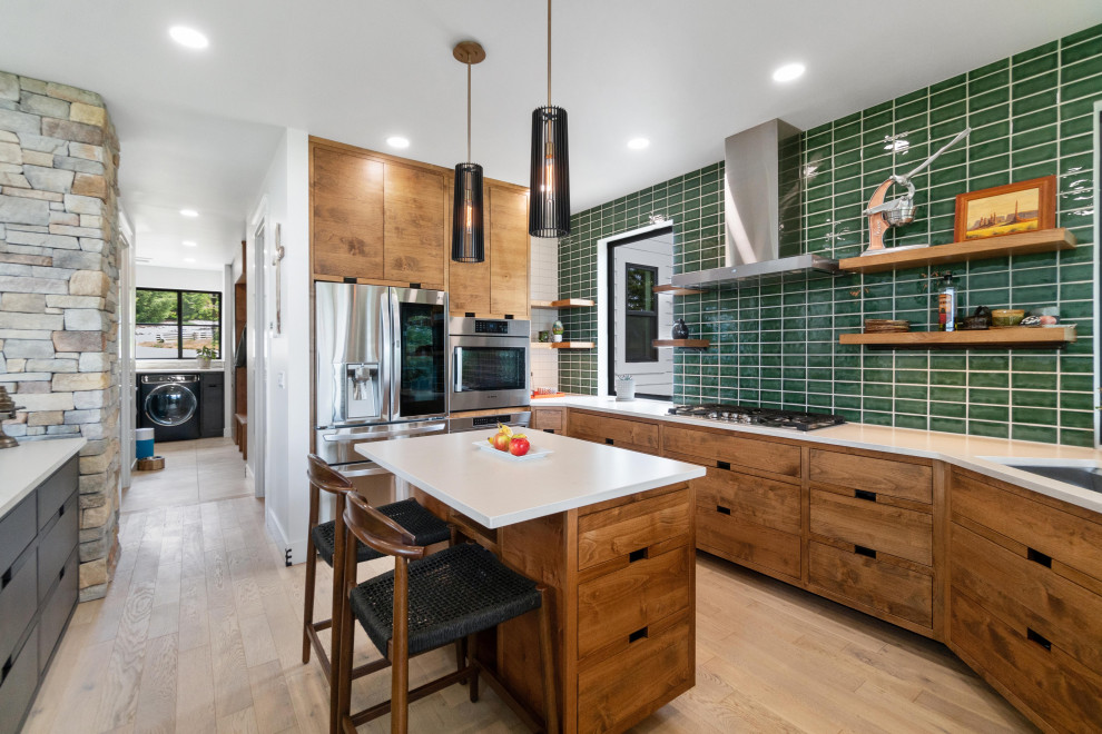 Large minimalist light wood floor eat-in kitchen photo in Seattle with an undermount sink, flat-panel cabinets, light wood cabinets, quartz countertops, green backsplash, glass tile backsplash, stainless steel appliances, an island and white countertops