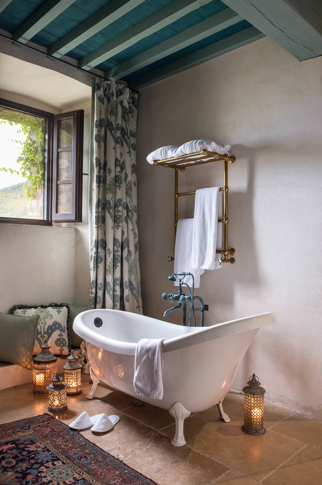 Inspiration for a mediterranean bathroom in Florence with a claw-foot tub and beige walls.