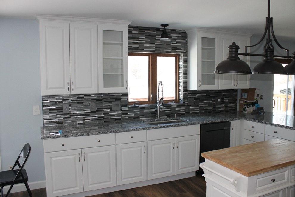 Kitchen - mid-sized transitional u-shaped dark wood floor and brown floor kitchen idea with an undermount sink, raised-panel cabinets, white cabinets, granite countertops, multicolored backsplash, matchstick tile backsplash, stainless steel appliances, an island and multicolored countertops