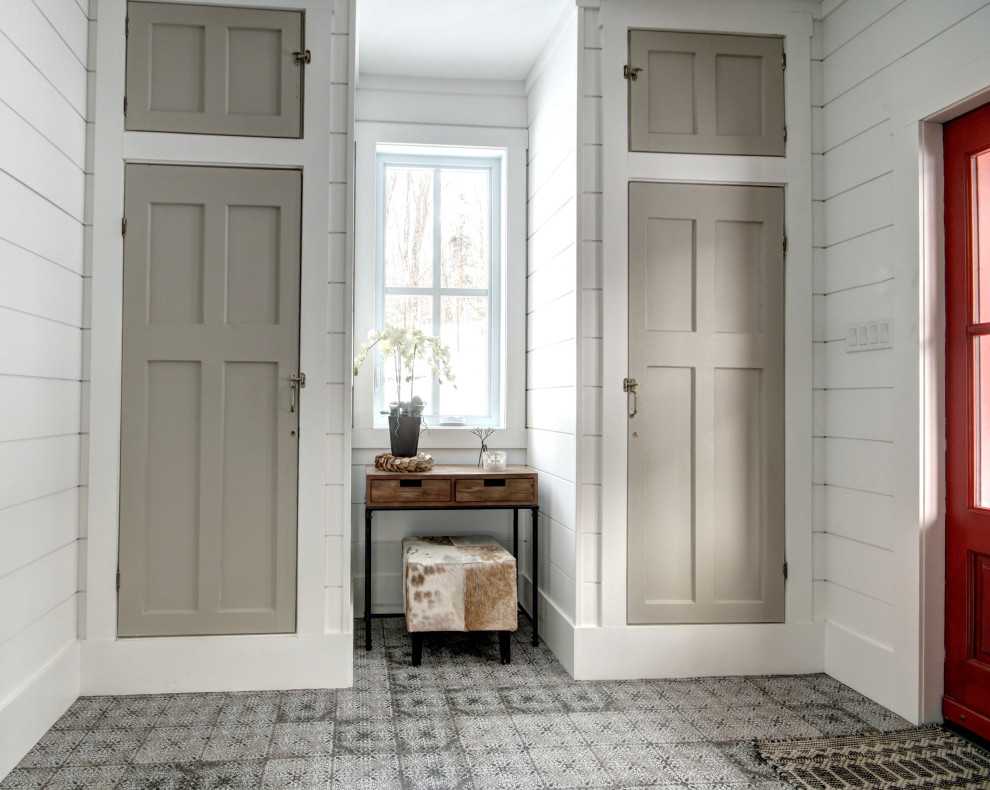 This is an example of a large country front door in Other with white walls, ceramic floors, a double front door, a red front door and white floor.