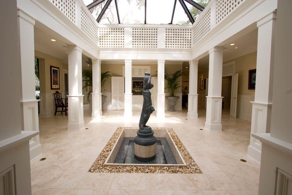 Inspiration for a mid-sized traditional foyer in Tampa with beige walls, travertine floors and beige floor.