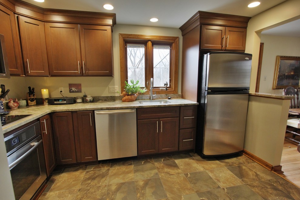 Inspiration for a mid-sized ceramic tile eat-in kitchen remodel with a single-bowl sink, medium tone wood cabinets, granite countertops, white backsplash, stainless steel appliances and no island