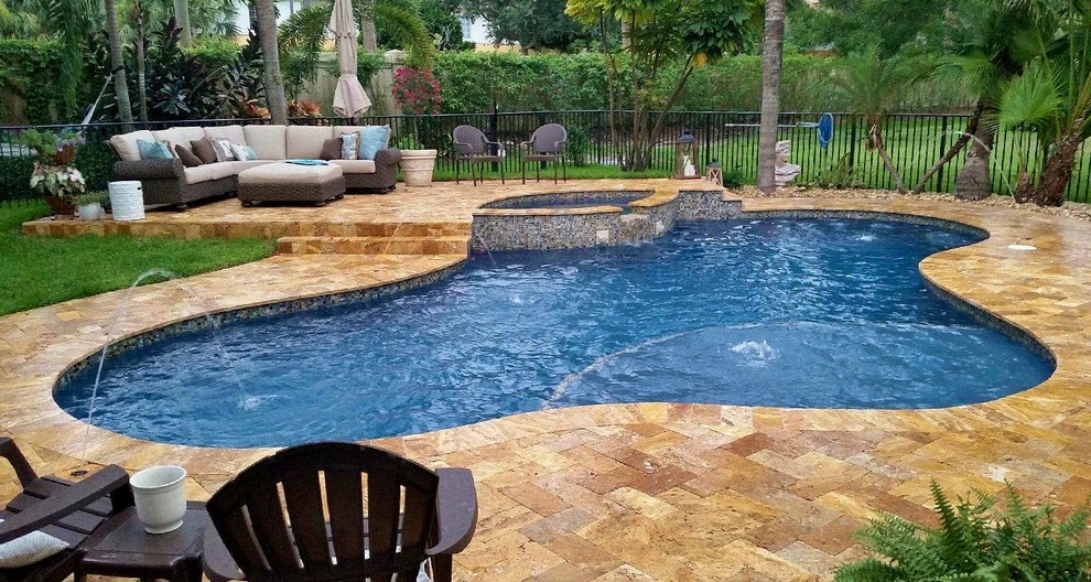 Pool fountain - large transitional backyard stone and custom-shaped natural pool fountain idea in Miami