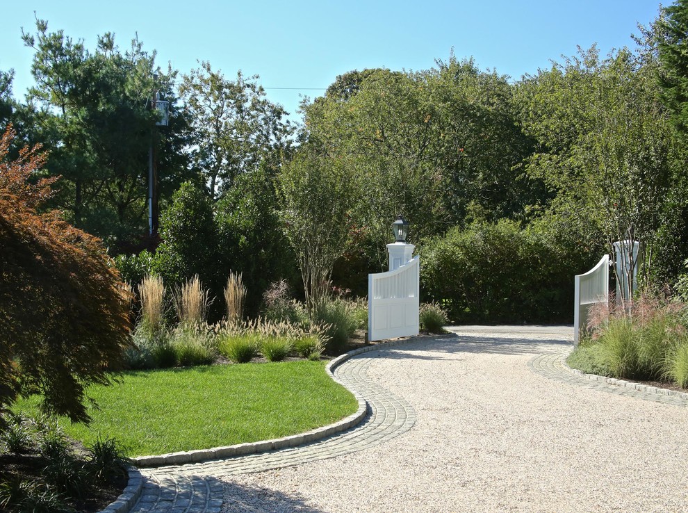 Photo of an expansive traditional front yard partial sun driveway in New York with gravel.