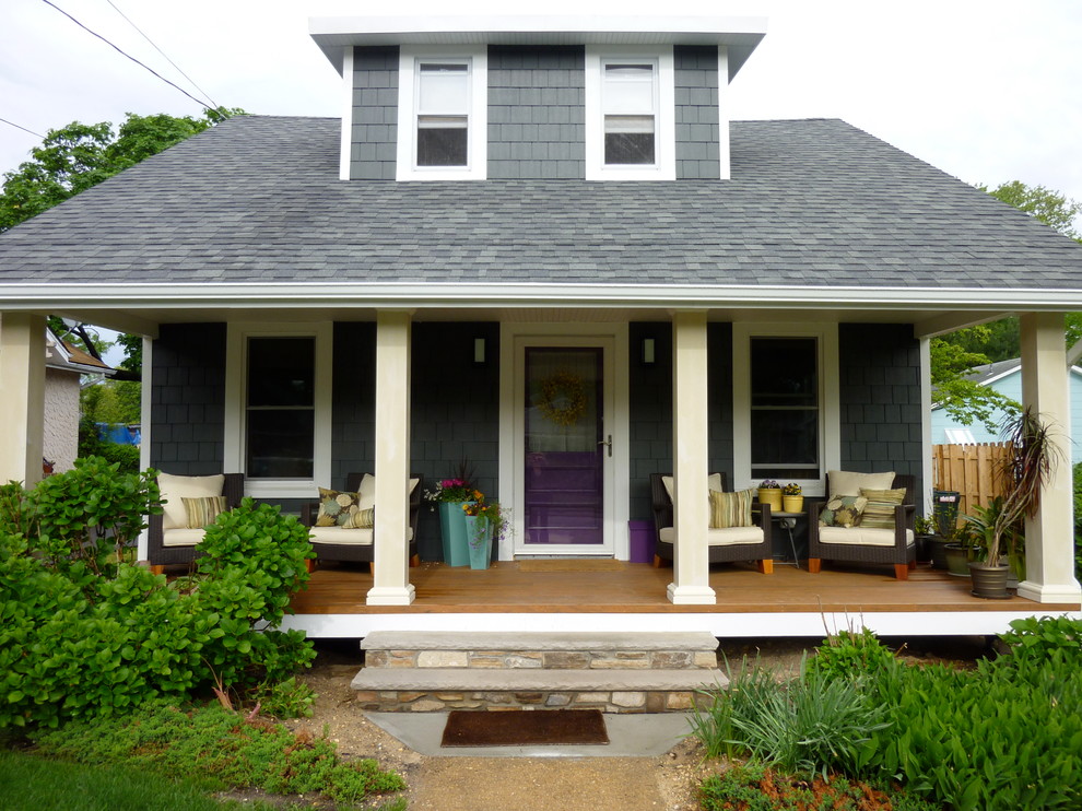 Inspiration for a mid-sized traditional two-storey grey exterior in New York with wood siding and a hip roof.