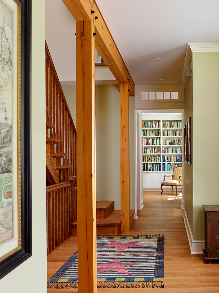 Design ideas for a large country hallway in Philadelphia with green walls and light hardwood floors.