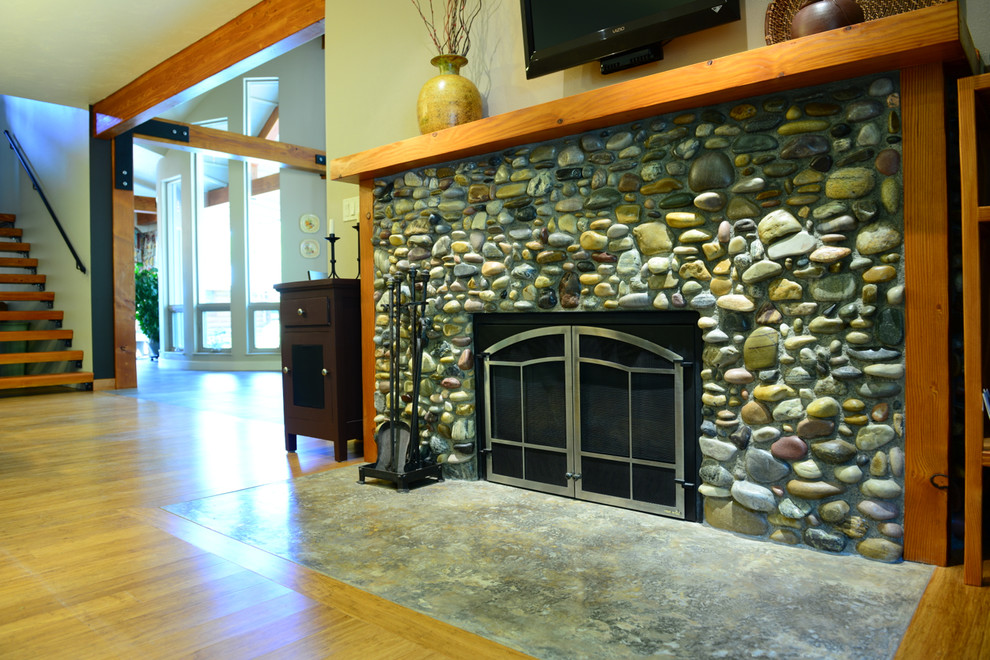 Photo of a mid-sized contemporary living room in Other with a standard fireplace and a stone fireplace surround.