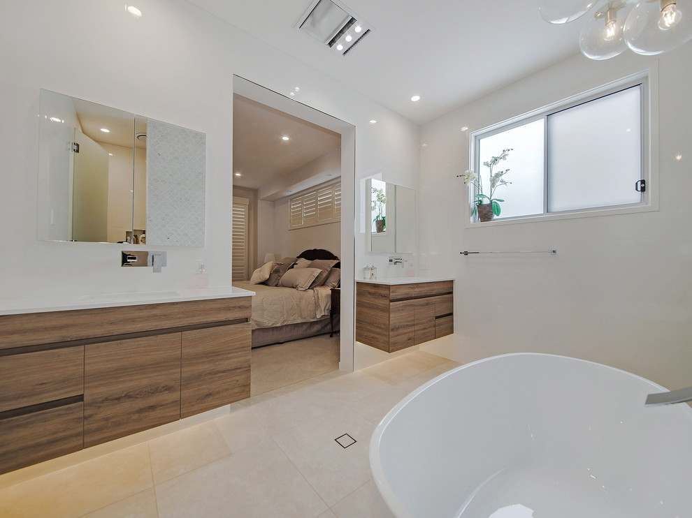 Design ideas for a large contemporary master wet room bathroom in Brisbane with flat-panel cabinets, dark wood cabinets, a freestanding tub, white tile, marble, white walls, an undermount sink, granite benchtops, beige floor and a hinged shower door.