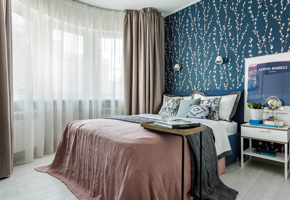 This is an example of a contemporary master bedroom in Moscow with blue walls, light hardwood floors and grey floor.