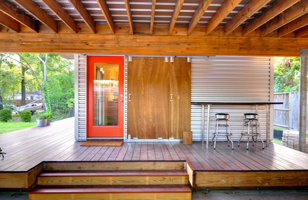 This is an example of a contemporary deck in Houston with a pergola.